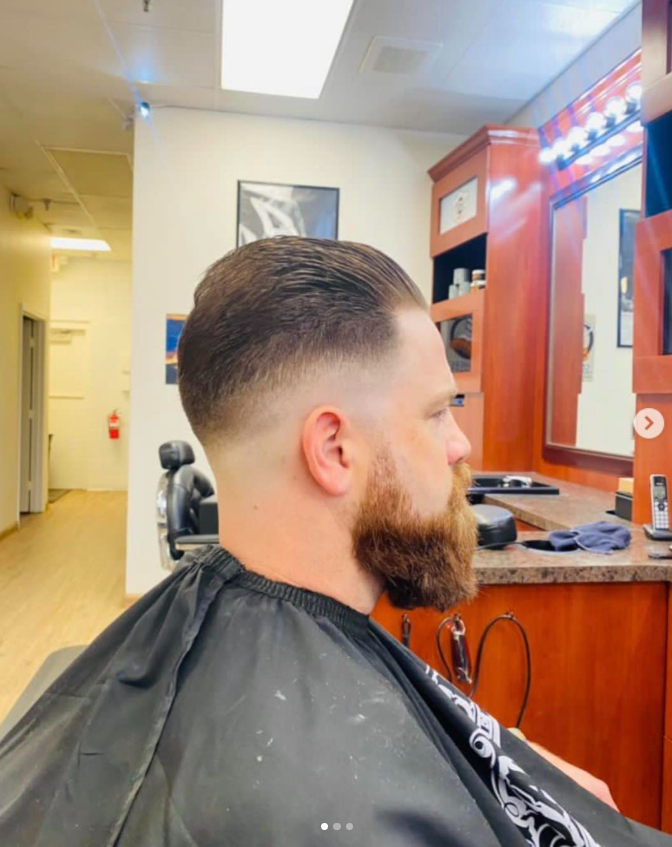 man in barbers chair getting hair cut
