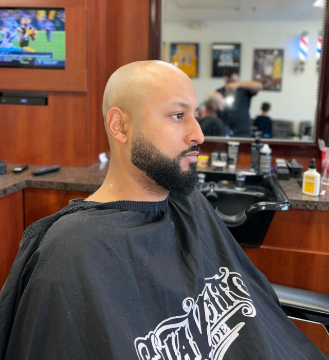 man in barbers chair with barber
