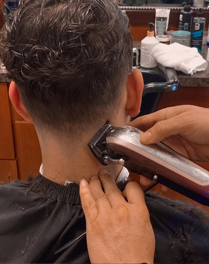 man in barbers chair getting hot towel